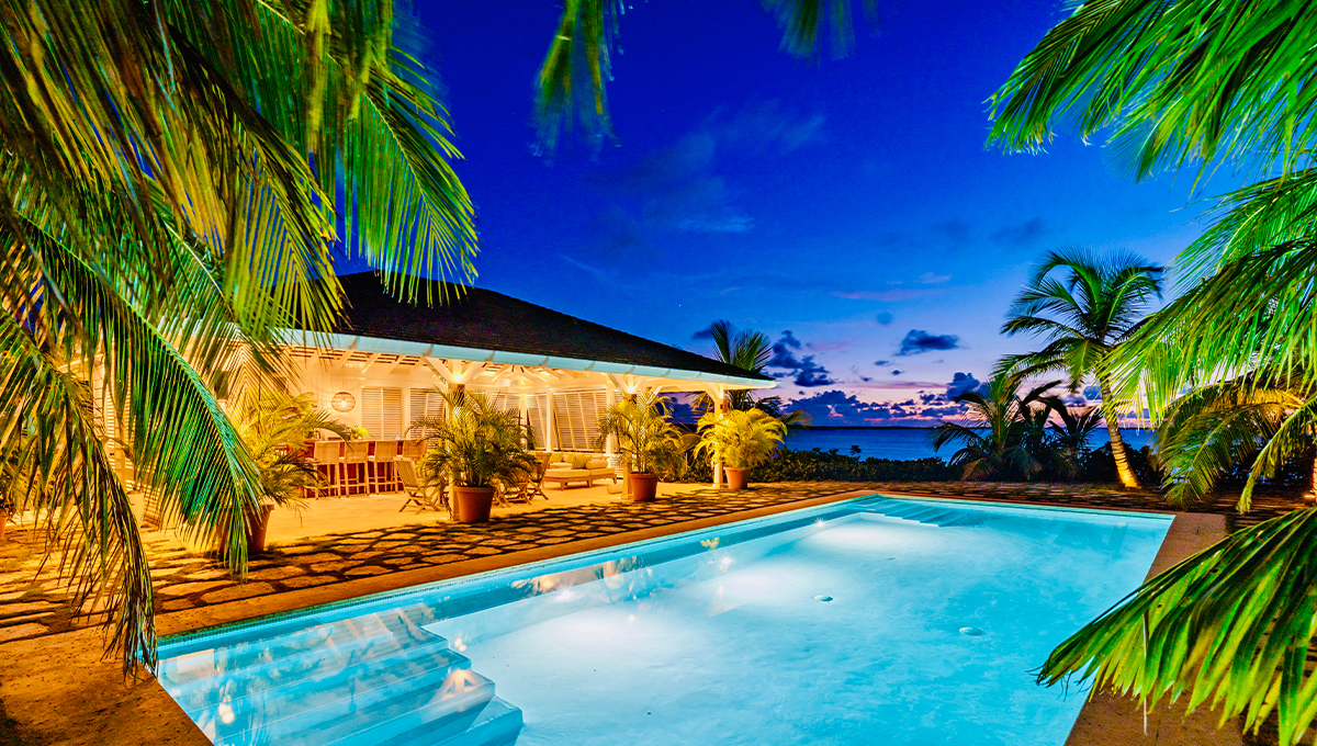 Luxury private villa rental vacation Bahamas pool after sunset